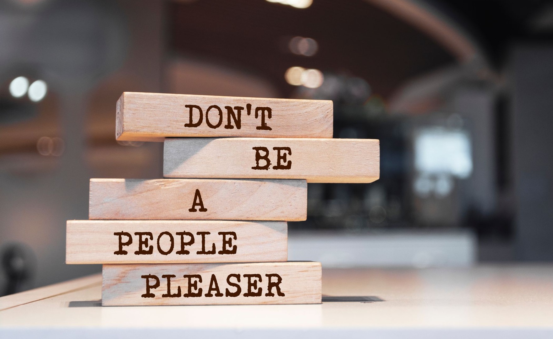 Photo of wooden blocks read out 'Don't be a people pleaser'