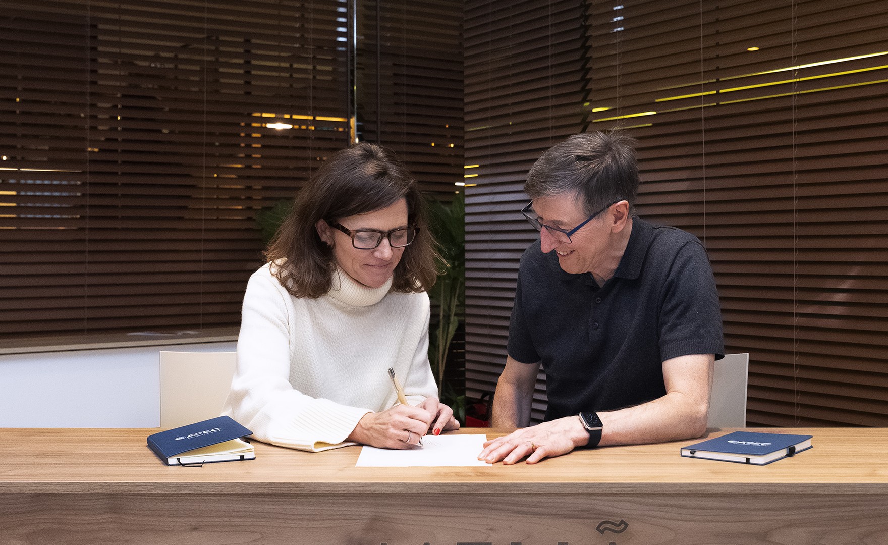 Photo of Virginia Molet and John Leary-Joyce signing contract