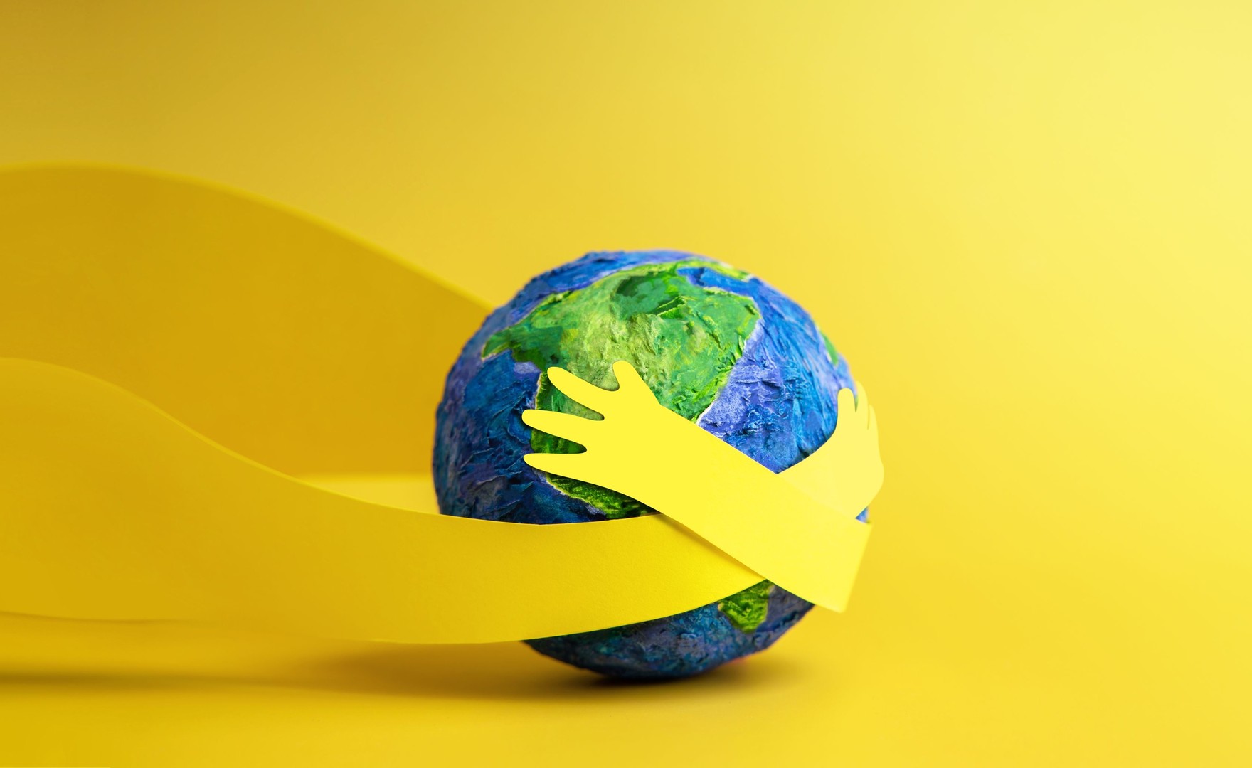 Image of arms wrapped around the world