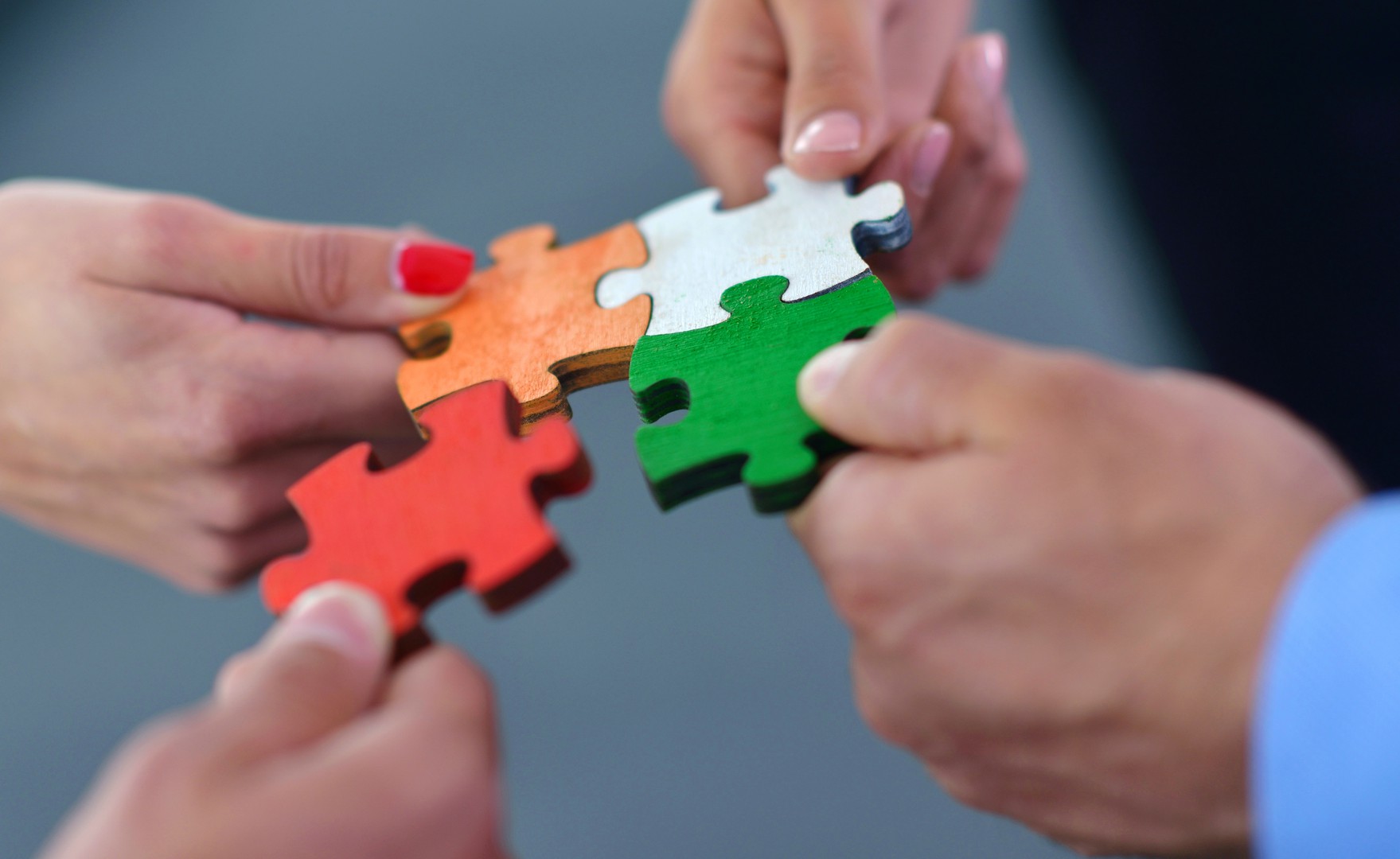 hands holding jigsaw pieces